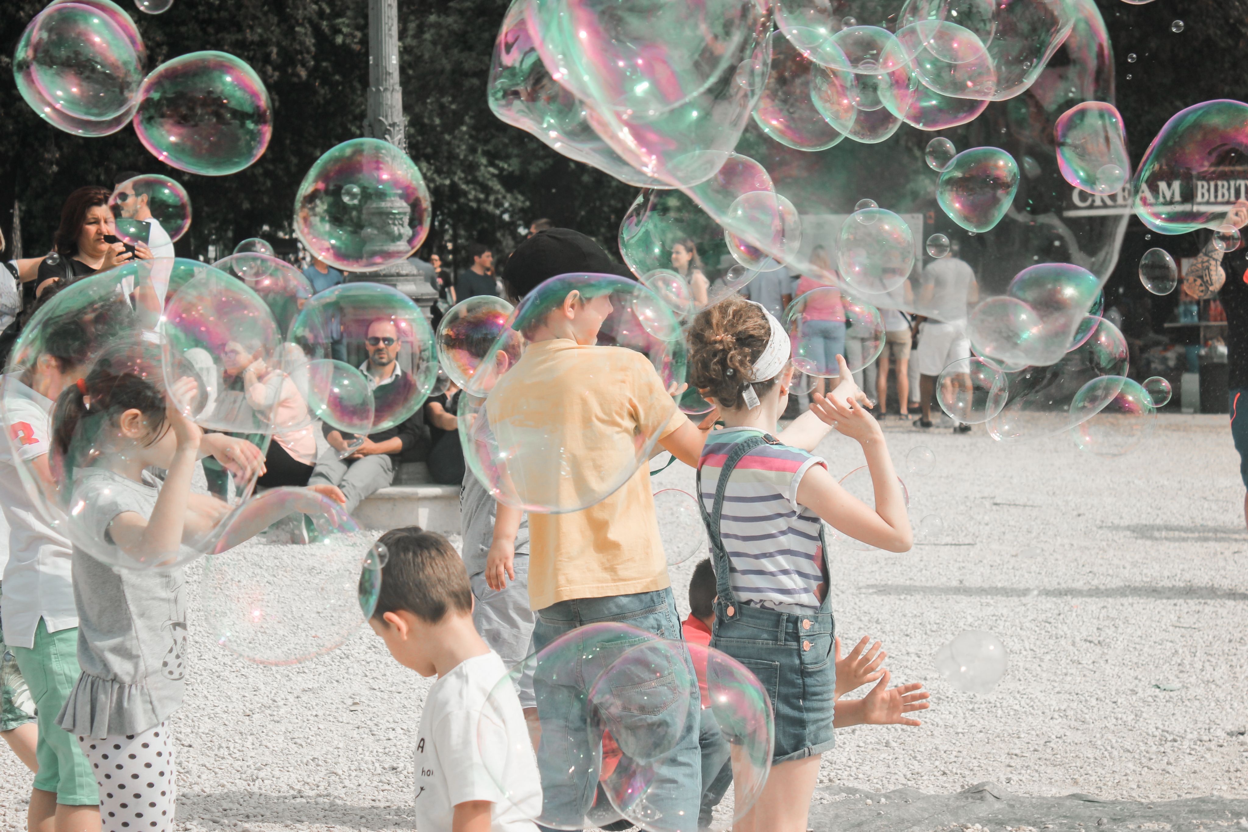 a group of children playing with soap bubbles