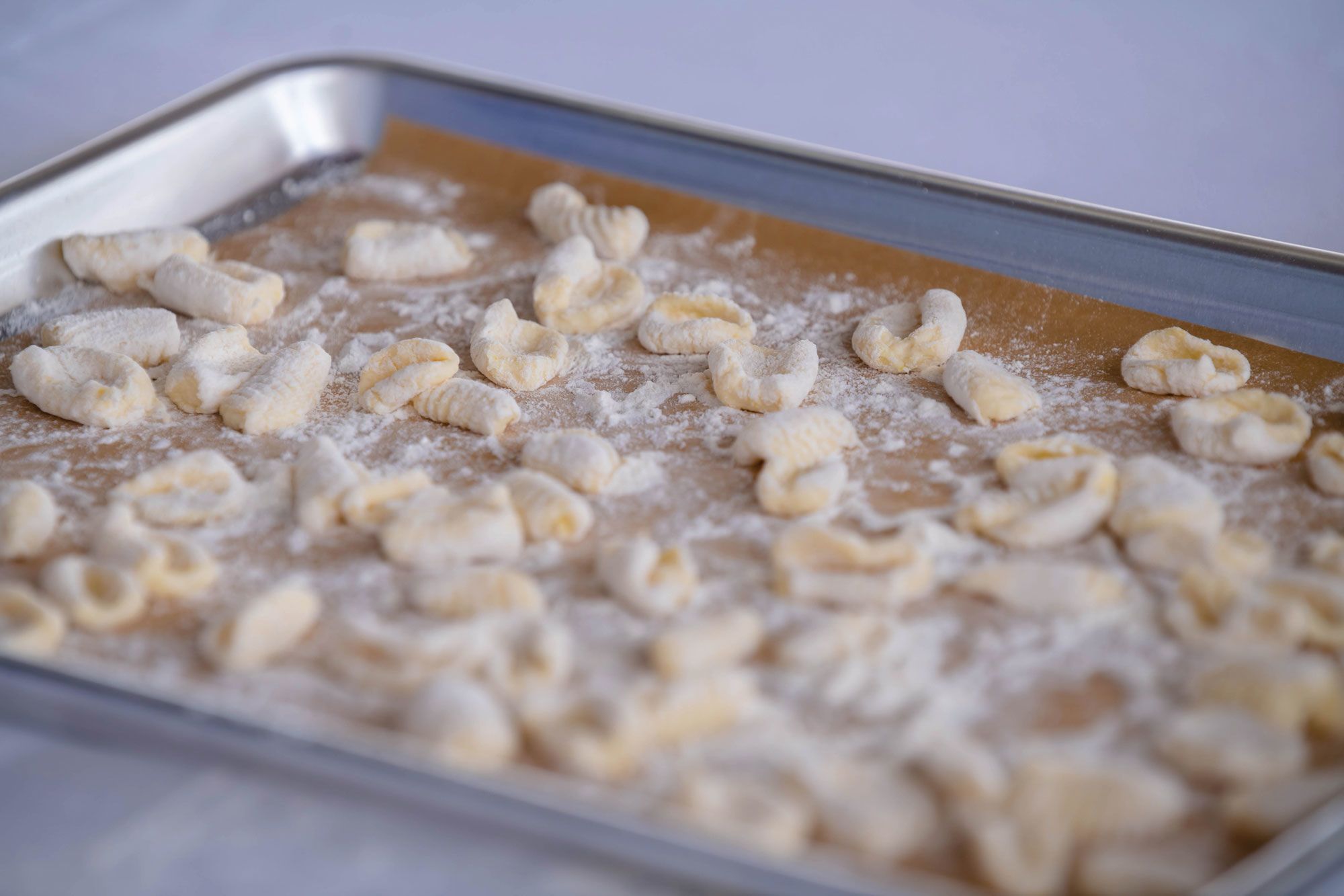 Gnocchi on a baking tray, prepped for cooking