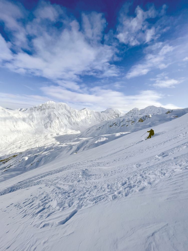 Wonderful view of mountain slope and skier sliding down on it