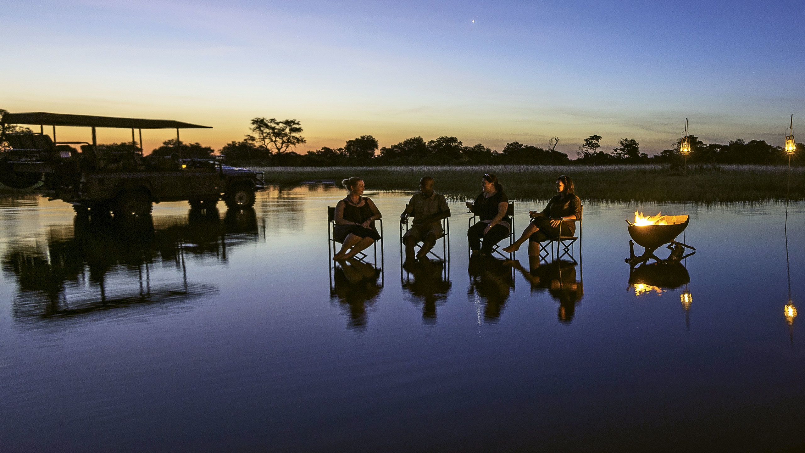 Sunset drinks in the Okavango Delta. Hard-to-reach destinations where travelers can enjoy wilderness without crowds make for unique luxury experiences. Photo courtesy of Wilderness Safaris/Dana Allen