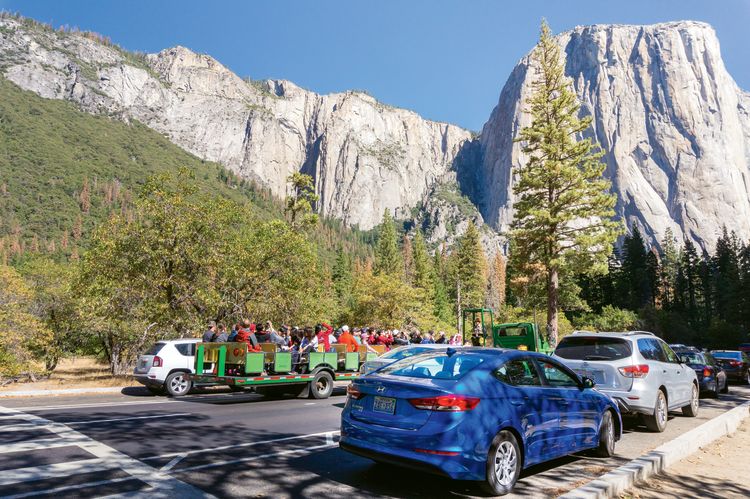 Tourists’ vehicles lined up to enter Yosemite National Park. Tech improvements, such as web fee payment, might ease congestion at park entrances. (Photo by Ayrat A/Shutterstock)